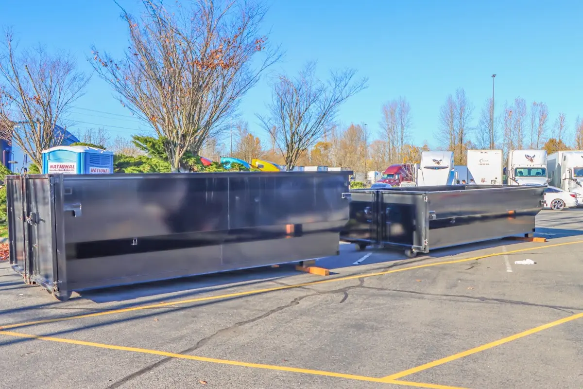 Professional dumpster rental service with roll-off container on residential driveway in Jupiter